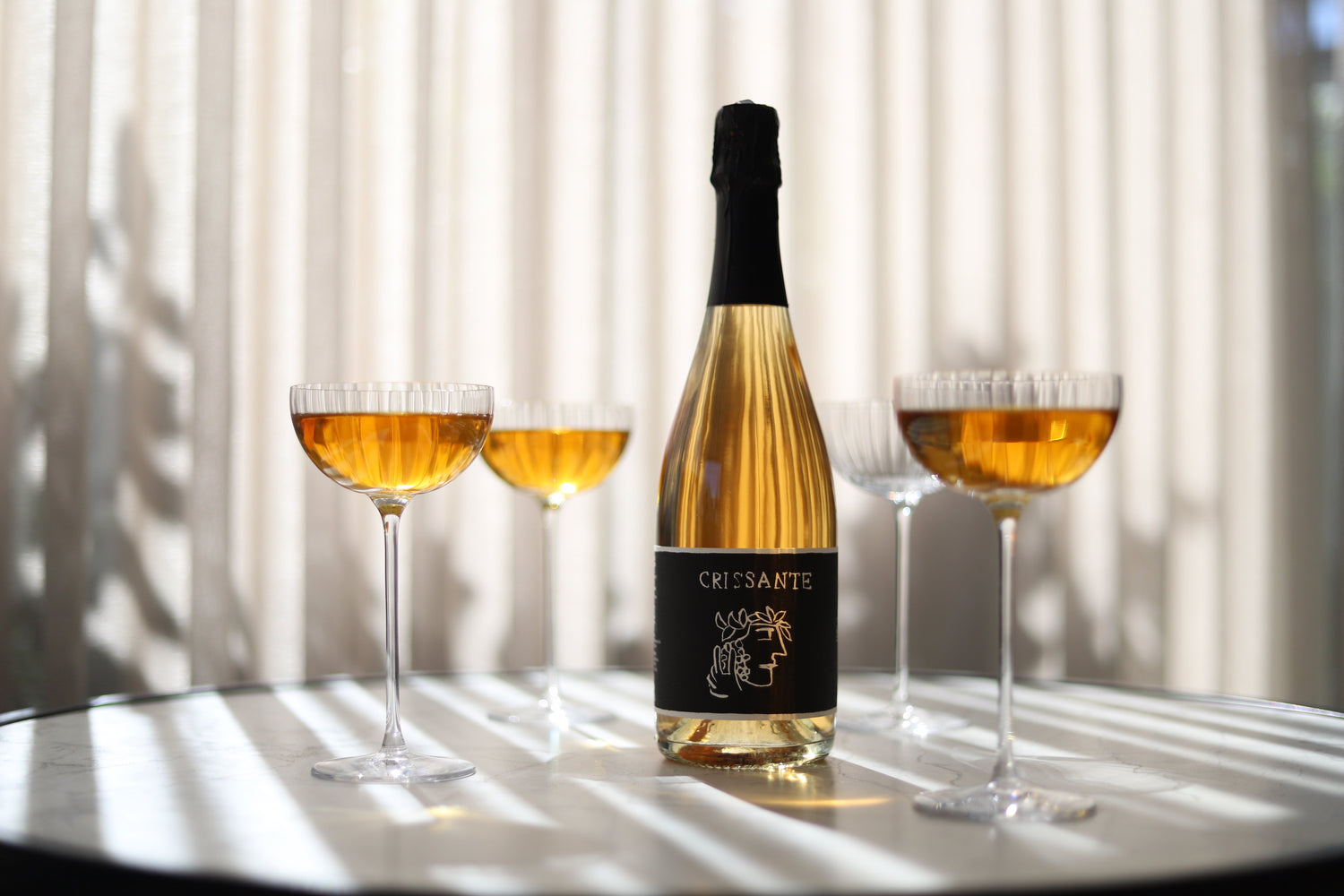 Sparkling wine bottles & poured glasses