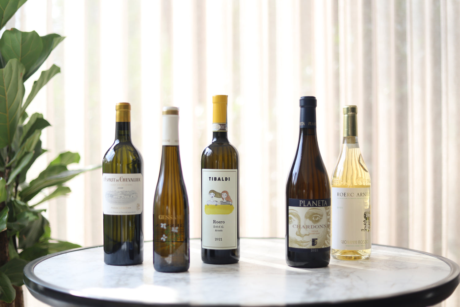 a variety of white wine bottles